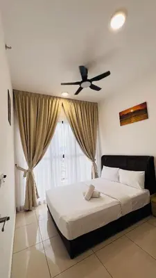 a bedroom with a bed and a ceiling fan at The Grand Suites - Trion KL in Kuala Lumpur