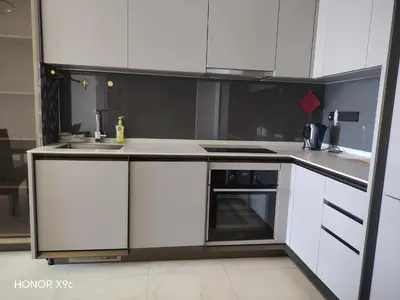 a white kitchen with a stove and a sink at Opus Residence KL118 By Millennium Suite in Kuala Lumpur