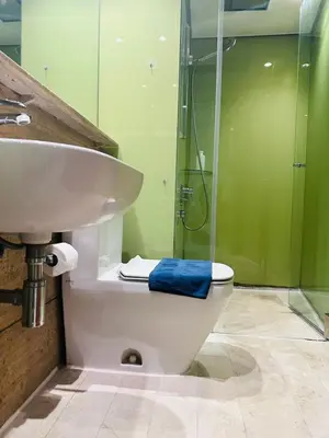 a bathroom with a toilet and a sink and a shower at Axora Sky Suites KLCC in Kuala Lumpur