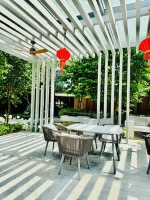 a patio with a table and chairs and red lanterns at Agile Residence Kuala Lumpur Bukit Bintang in Kuala Lumpur
