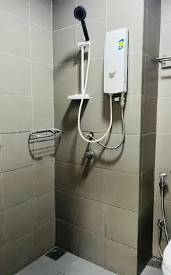 a bathroom with a shower with a hair dryer on the wall at Lux Retreat Home At Mercu Summer in Kuala Lumpur