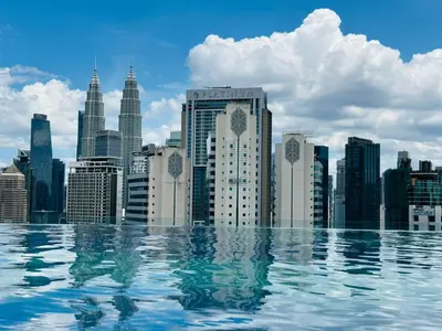 a view of a city skyline from a swimming pool at Majestic Suites klcc By EQ in Kuala Lumpur