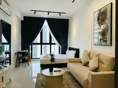 a living room with a couch and a bed at Majestic Suites klcc By EQ in Kuala Lumpur