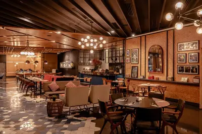 a restaurant with tables and chairs and a bar at The Kuala Lumpur Journal Hotel in Kuala Lumpur