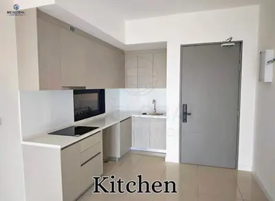 a kitchen with white cabinets and a white door at Skyline Suites Kuala Lumpur in Kuala Lumpur
