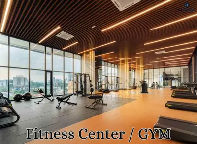 a fitness center with a gym with tread machines and windows at Skyline Suites Kuala Lumpur in Kuala Lumpur