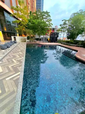 a large swimming pool in the middle of a city at LUCENTIA RESIDENCE by ROOMZONE MALAYSIA BUKIT BINTANG,KLCC in Kuala Lumpur