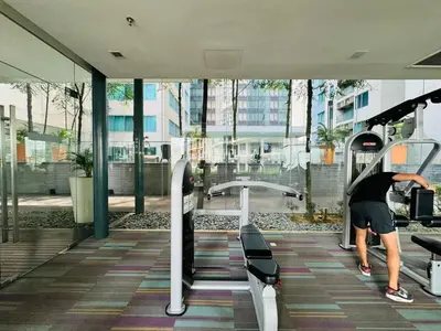 a man on a treadmill in a gym at Elegant Home at Mercu Summer Suites By KLCC in Kuala Lumpur