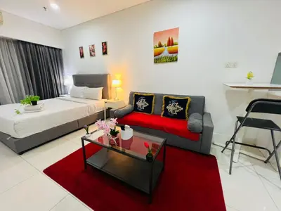 a living room with a bed and a couch at Elegant Home at Mercu Summer Suites By KLCC in Kuala Lumpur