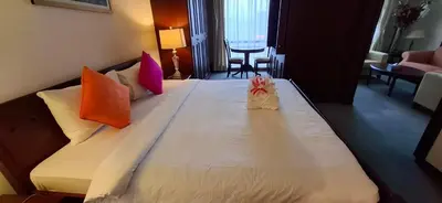 a hotel room with a large white bed with colorful pillows at Kuala Lumpur Service suite times square s in Kuala Lumpur