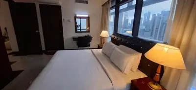 a bedroom with a large bed with a large window at Kuala Lumpur Service suite times square s in Kuala Lumpur