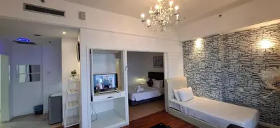 a bedroom with a bed and a chandelier at Kuala Lumpur Service suite times square s in Kuala Lumpur
