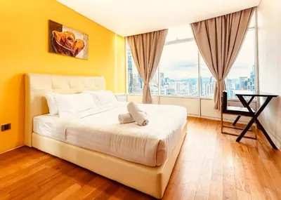 a bedroom with a white bed and a large window at Vortex Klcc By welcomes in Kuala Lumpur
