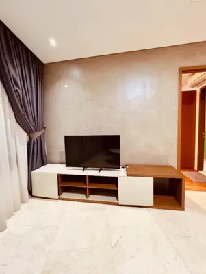 a living room with a flat screen tv on a wall at Vortex Klcc By welcomes in Kuala Lumpur