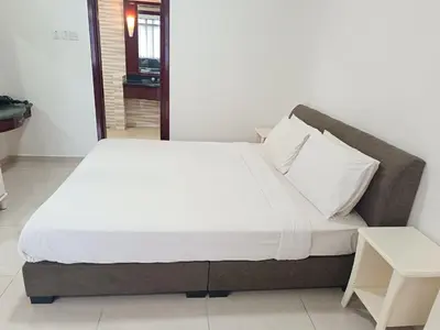 a large bed in a room with a white bedspread at Berjaya Times Square KLCC by cozy stay in Kuala Lumpur