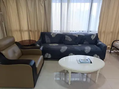 a living room with a couch and a table at Berjaya Times Square KLCC by cozy stay in Kuala Lumpur