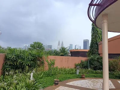 a garden with a city skyline in the background at Berjaya Times Square KLCC by cozy stay in Kuala Lumpur