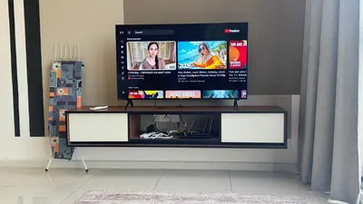 a flat screen tv sitting on top of a entertainment center at Majestic Suites KLCC by Aman Tokyo in Kuala Lumpur