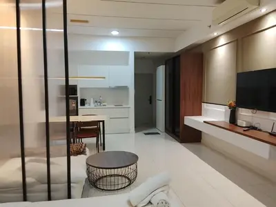 a living room with a television and a table at Mix Home At Chamber Residence in Kuala Lumpur