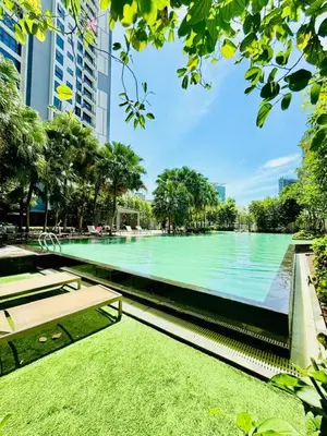 a large swimming pool in a city with trees at Agile Residence By Infinity Pool in Kuala Lumpur