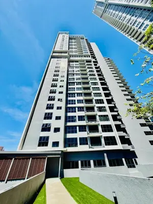 a tall white building with grass in front of it at Agile Residence By Infinity Pool in Kuala Lumpur