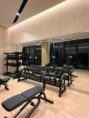 a gym with several rows of exercise equipment at Axon KL Infinity Pool Suites near Pavilion in Kuala Lumpur
