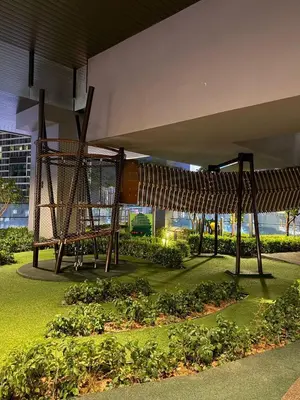 a park with a bunch of plants under a building at Axon KL Infinity Pool Suites near Pavilion in Kuala Lumpur