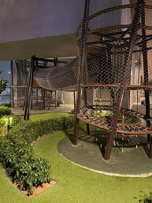 a playground with a spiral staircase in a park at Axon KL Infinity Pool Suites near Pavilion in Kuala Lumpur