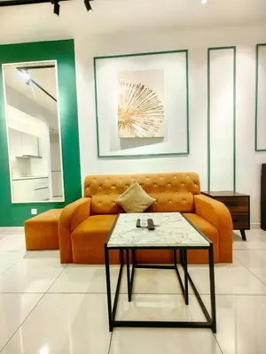 a living room with a couch and a table at Chambers Residence Specious Suites KlCC in Kuala Lumpur