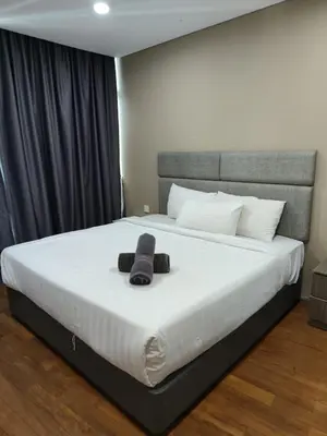 a bedroom with a large white bed with a hat on it at Vortex Suite Klcc By Sky Moon in Kuala Lumpur