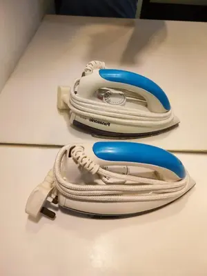 a white and blue phone sitting on a table at Vortex Suite Klcc By Sky Moon in Kuala Lumpur