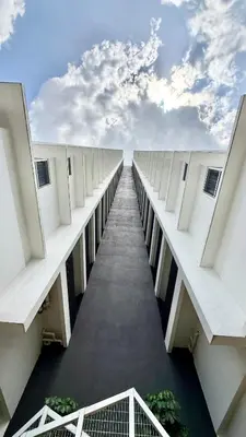 a long corridor of a building with the sky in the background at Kuala Lumpur Quill Residences By AR Stay in Kuala Lumpur
