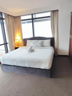 a bedroom with a bed with a large window at Moonlight Apartment service at Times Square kl in Kuala Lumpur