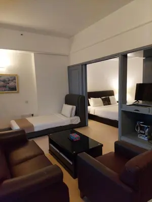 a room with a living room with a couch and a bed at Moonlight Apartment service at Times Square kl in Kuala Lumpur