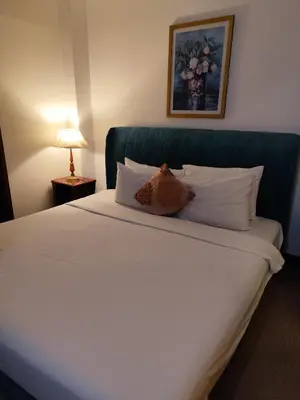 a bed in a hotel room with a pillow on it at Moonlight Apartment service at Times Square kl in Kuala Lumpur