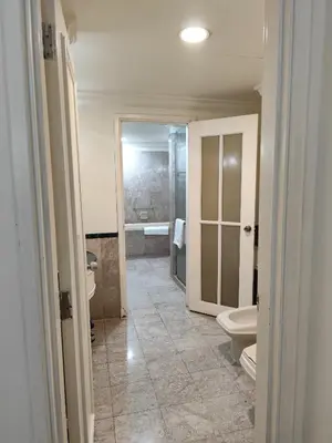 a bathroom with two toilets and a sink at Moonlight Apartment service at Times Square kl in Kuala Lumpur