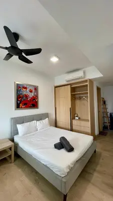 a bedroom with a bed with a ceiling fan at The Colony SkyView KLCC by Alaman in Kuala Lumpur