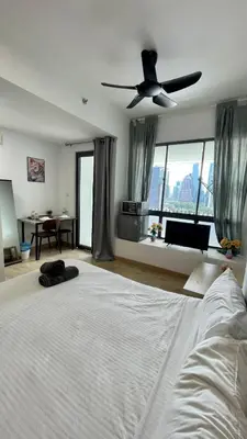 a bedroom with a white bed with a ceiling fan at The Colony SkyView KLCC by Alaman in Kuala Lumpur