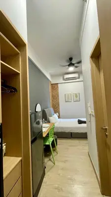a room with a bedroom with a bed and a table at The Colony SkyView KLCC by Alaman in Kuala Lumpur