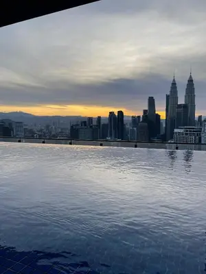 a infinity pool with a view of a city at The Colony SkyView KLCC by Alaman in Kuala Lumpur
