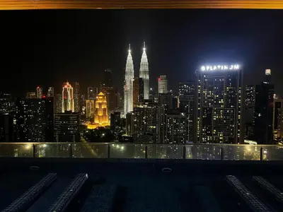 a view of a city skyline at night at The Colony SkyView KLCC by Alaman in Kuala Lumpur