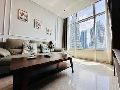 a living room with a couch and a large window at SKY SUiTES KLCC BY RT GROUP in Kuala Lumpur