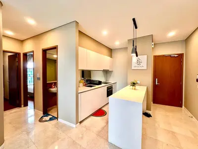 a kitchen with white cabinets and a white counter top at SKY SUiTES KLCC BY RT GROUP in Kuala Lumpur