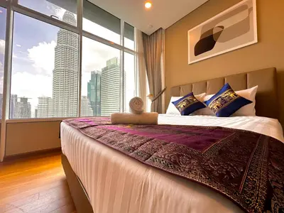 a bedroom with a large bed with a large window at SKY SUiTES KLCC BY RT GROUP in Kuala Lumpur