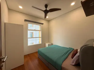 a bedroom with a bed and a ceiling fan at SKY SUiTES KLCC BY RT GROUP in Kuala Lumpur