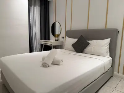 a white bed with a towel on top of it at Infinity pool luxury Apartment Axon in Kuala Lumpur