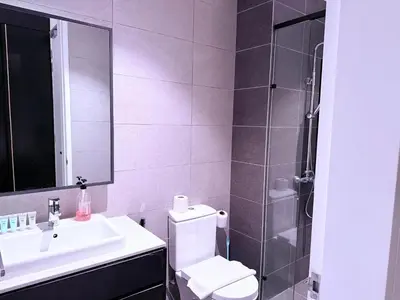 a bathroom with a toilet and a sink and a shower at Infinity pool luxury Apartment Axon in Kuala Lumpur