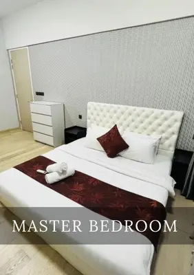 a bedroom with a large bed with a white headboard at Metro Star KLCC Living in Kuala Lumpur