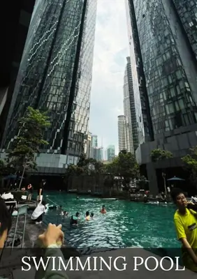 a swimming pool in a city with people in it at Metro Star KLCC Living in Kuala Lumpur