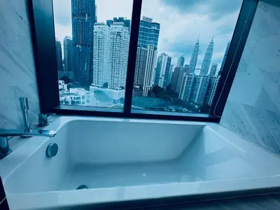 a bath tub in a bathroom with a large window at Eaton Residences By Tropika KLCC in Kuala Lumpur